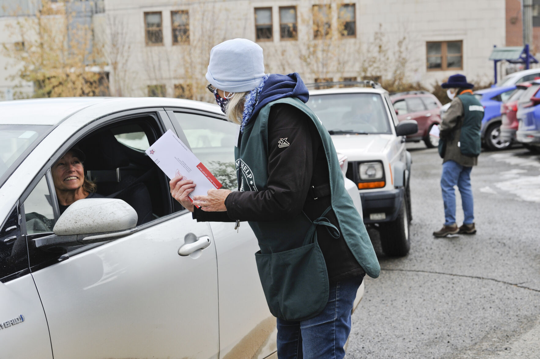 Poll worker Rebecca Johnson receives a ballot